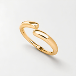 Gold open cuff bangle bracelet for women featuring a sleek polished finish and modern sculptural teardrop ends on a white background.