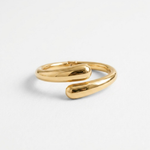Gold open cuff bangle bracelet for women shown from an angled view, featuring a smooth polished finish and curved teardrop ends.