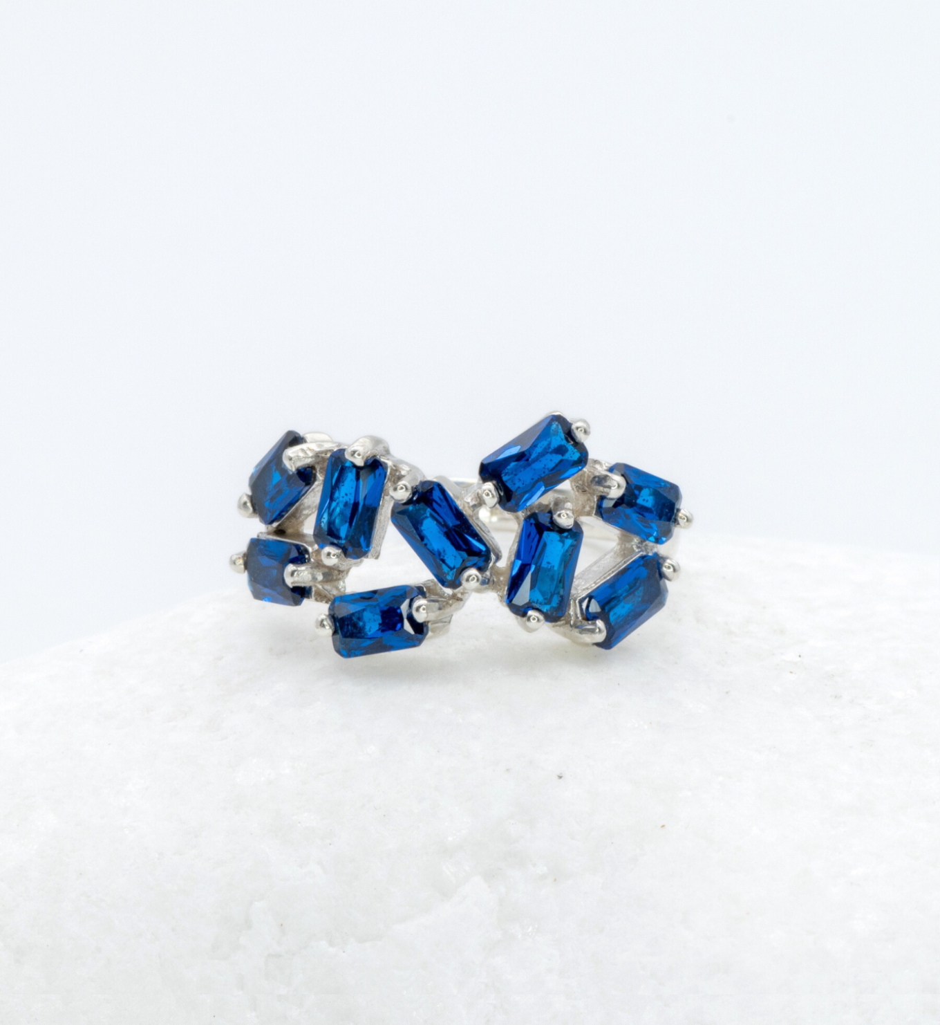 925 Sterling Silver ring with Sapphire September birthstone in emerald cut and prong setting. Blue gemstone ring ideal for as personalized gift or birthday present. Sapphire encourages truth, mental clarity, and spiritual insight. For wisdom, loyalty, focus.