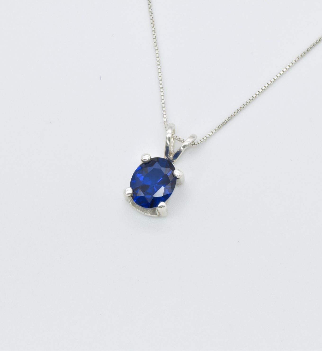 925 Sterling Silver necklace with Sapphire September birthstone in oval cut and prong setting. Blue gemstone pendant ideal as birthday present, and for everyday wear. Solitaire sapphire pendant encourages truth, mental clarity, and spiritual insight. For wisdom, loyalty, focus