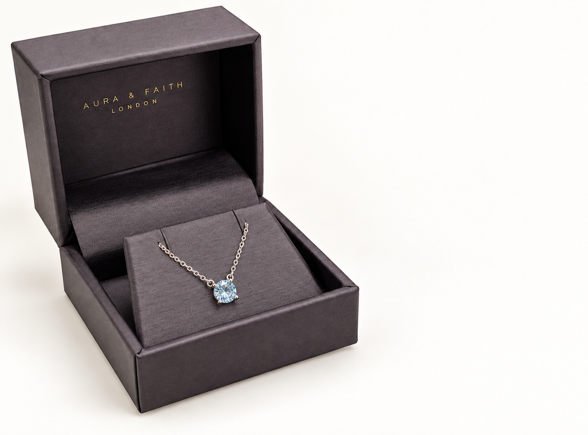 Sky blue topaz pendant necklace in Aura and Faith presentation box, angled view