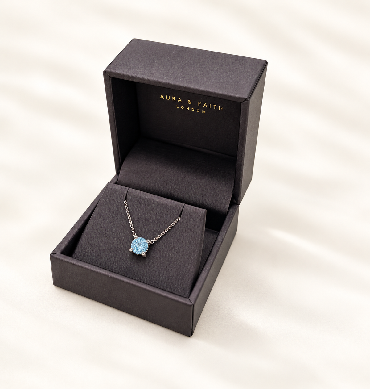 Sky blue topaz pendant necklace presented in Aura and Faith box