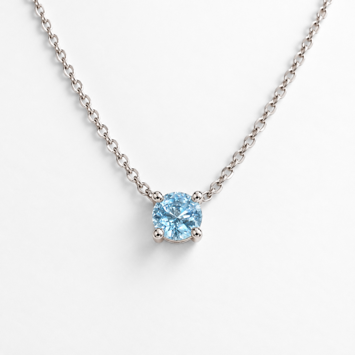Round sky blue topaz white gold pendant necklace, front view