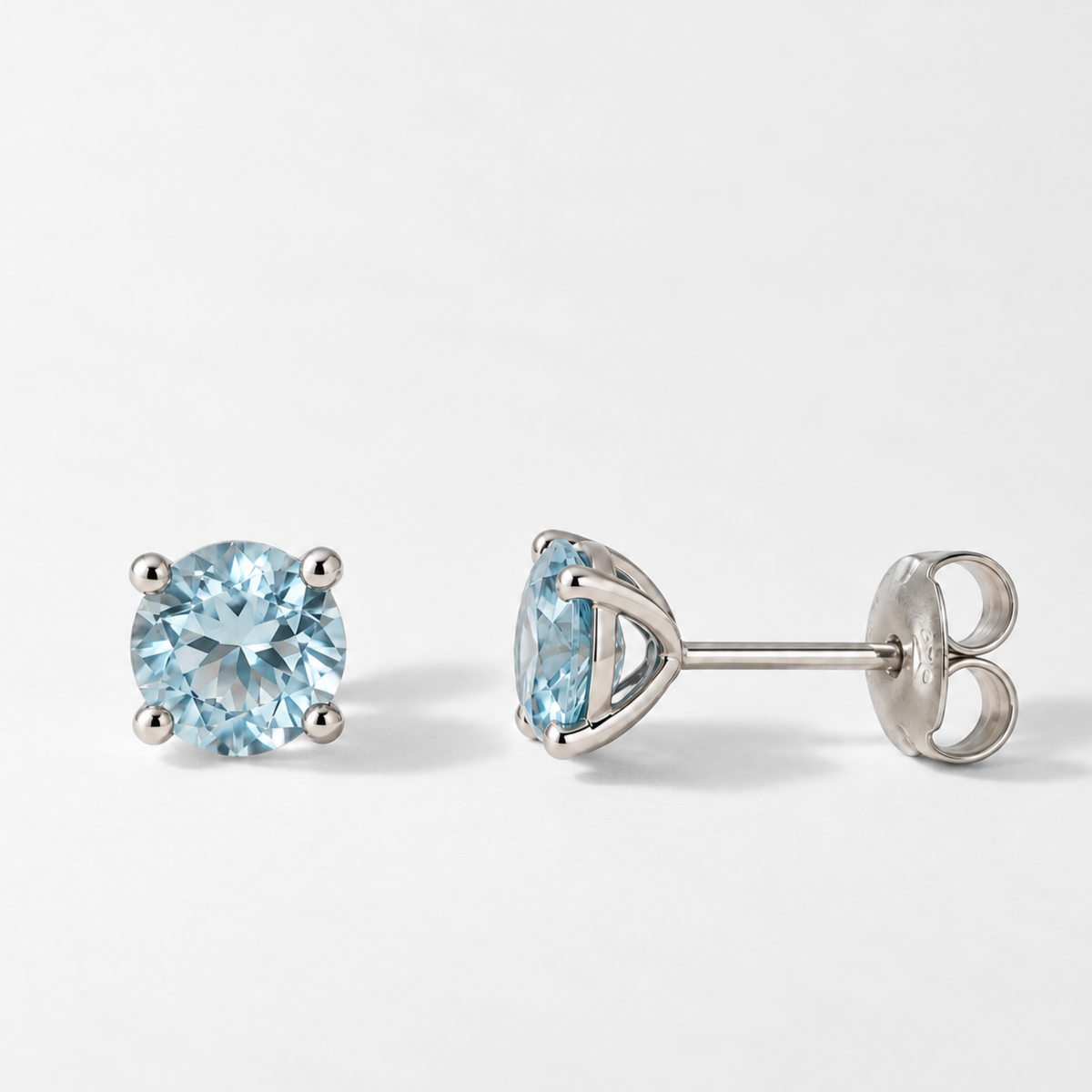 Blue topaz stud earring front and side with butterfly back