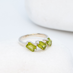 925 Sterling Silver ring with peridot august birthstone in baguette cut and prong setting. Three stone ring ideal for birthday gift and special events. Promotes emotional balance, joy, and clears negative energy. For abundance, healing, protection