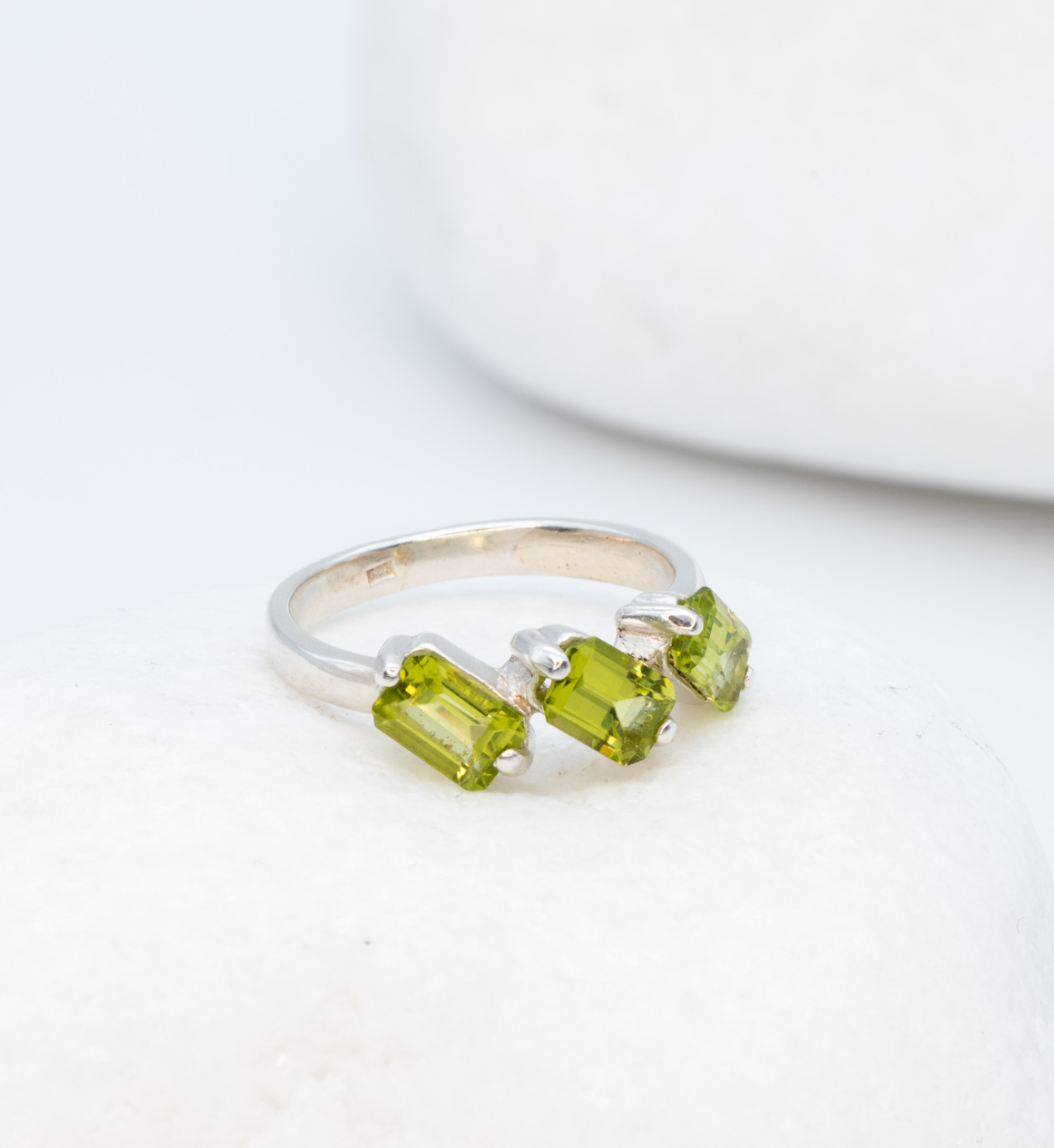 925 Sterling Silver ring with peridot august birthstone in baguette cut and prong setting. Three stone ring ideal for birthday gift and special events. Promotes emotional balance, joy, and clears negative energy. For abundance, healing, protection