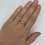 Gold Aquamarine Ring worn on middle finger