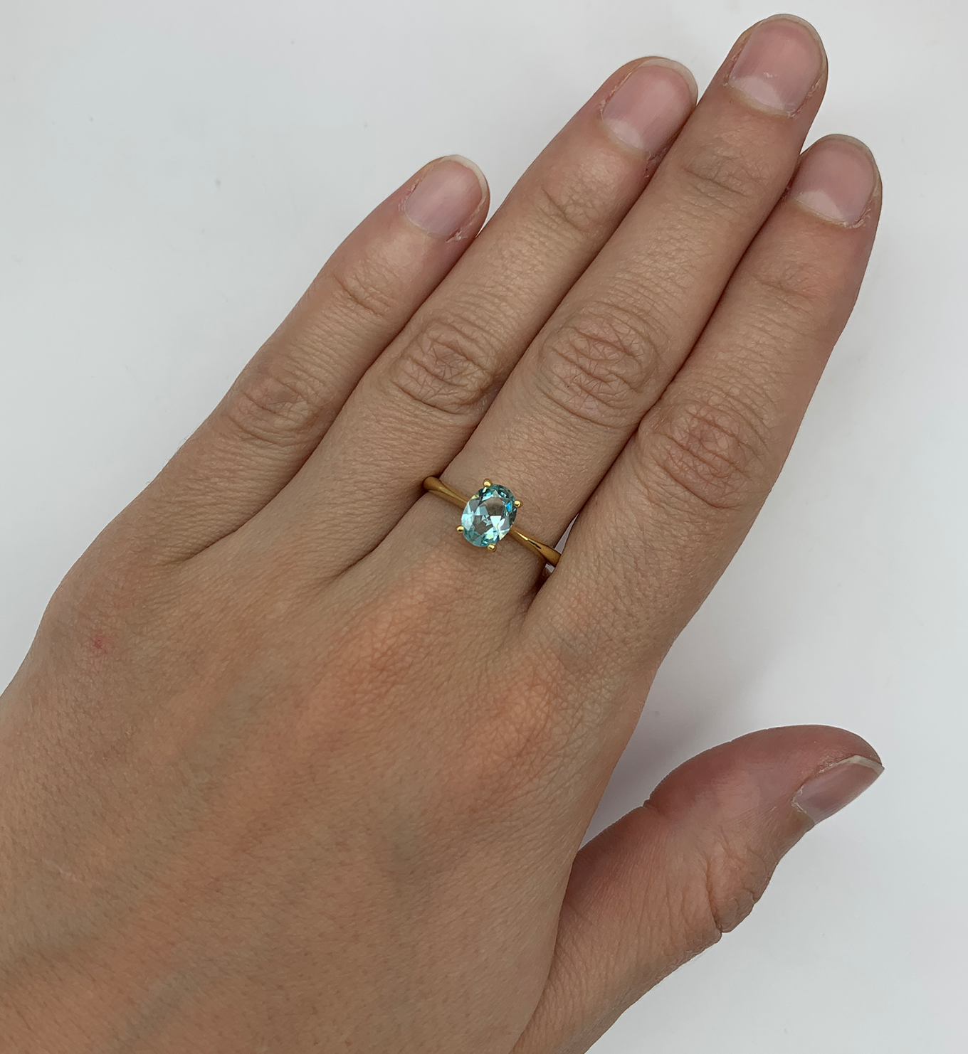 Gold Aquamarine Ring worn on middle finger