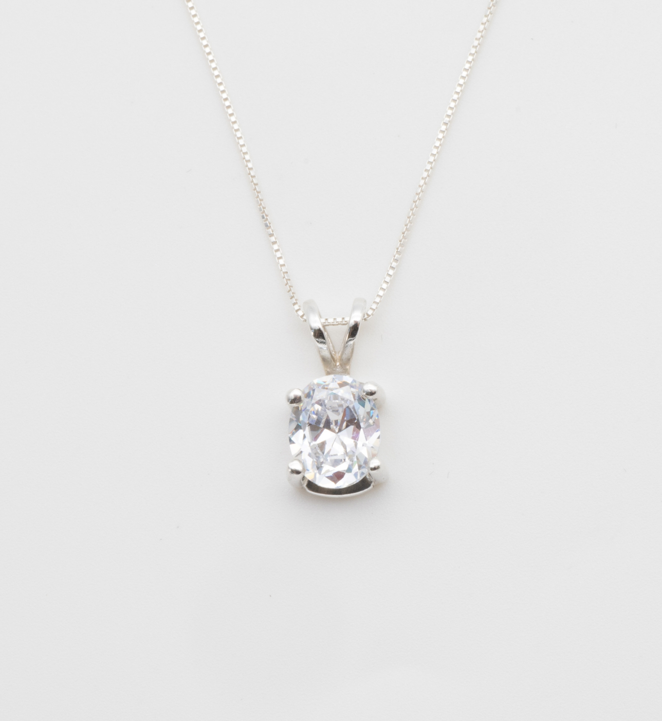 Diamond Solitaire Necklace set in solid 925 sterling silver, April birthstone in an oval cut, and prong setting. Diamond pendant ideal for casual and formal occasions. CZ Diamond symbolizes eternal love, purity, and inner strength. For strength, clarity, abundance
