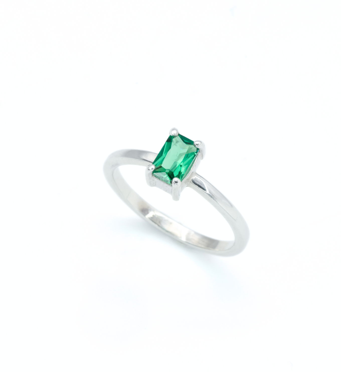 925 Sterling Silver ring with emerald may birthstone in baguette cut and prong setting. Solitaire ring ideal for special occasions and stacking rings. Encourages growth, harmony, and deep emotional healing.
