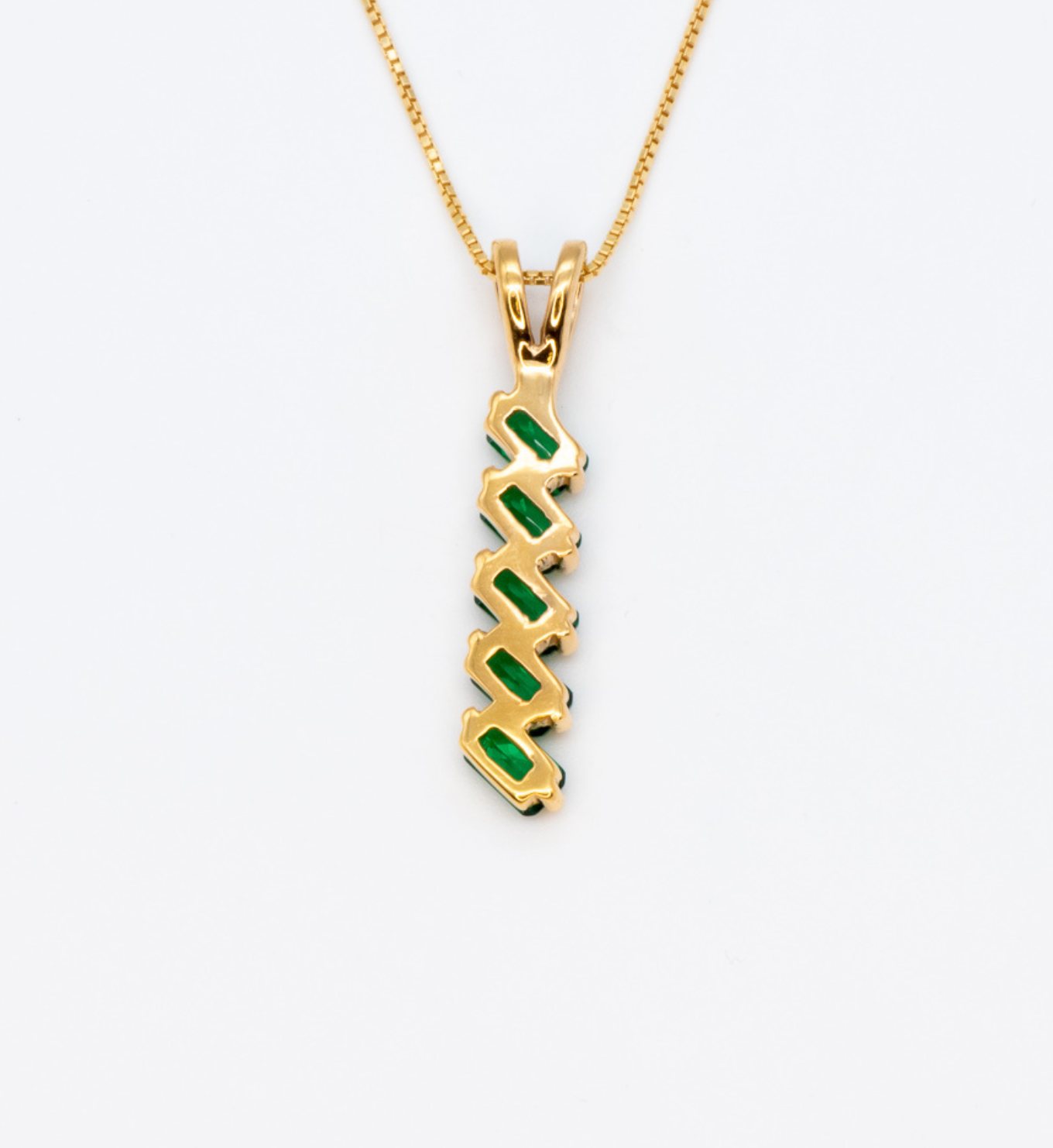 18k Yellow Gold necklace set with emerald may birthstone, in stunning green color, prong setting, and baguette cut. Vertical emerald pendant for her, perfect for date nights, and for special occasions
