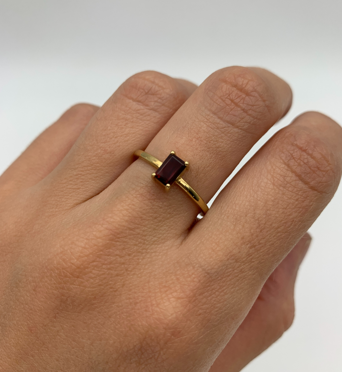 Gold Garnet Ring worn in middle finger