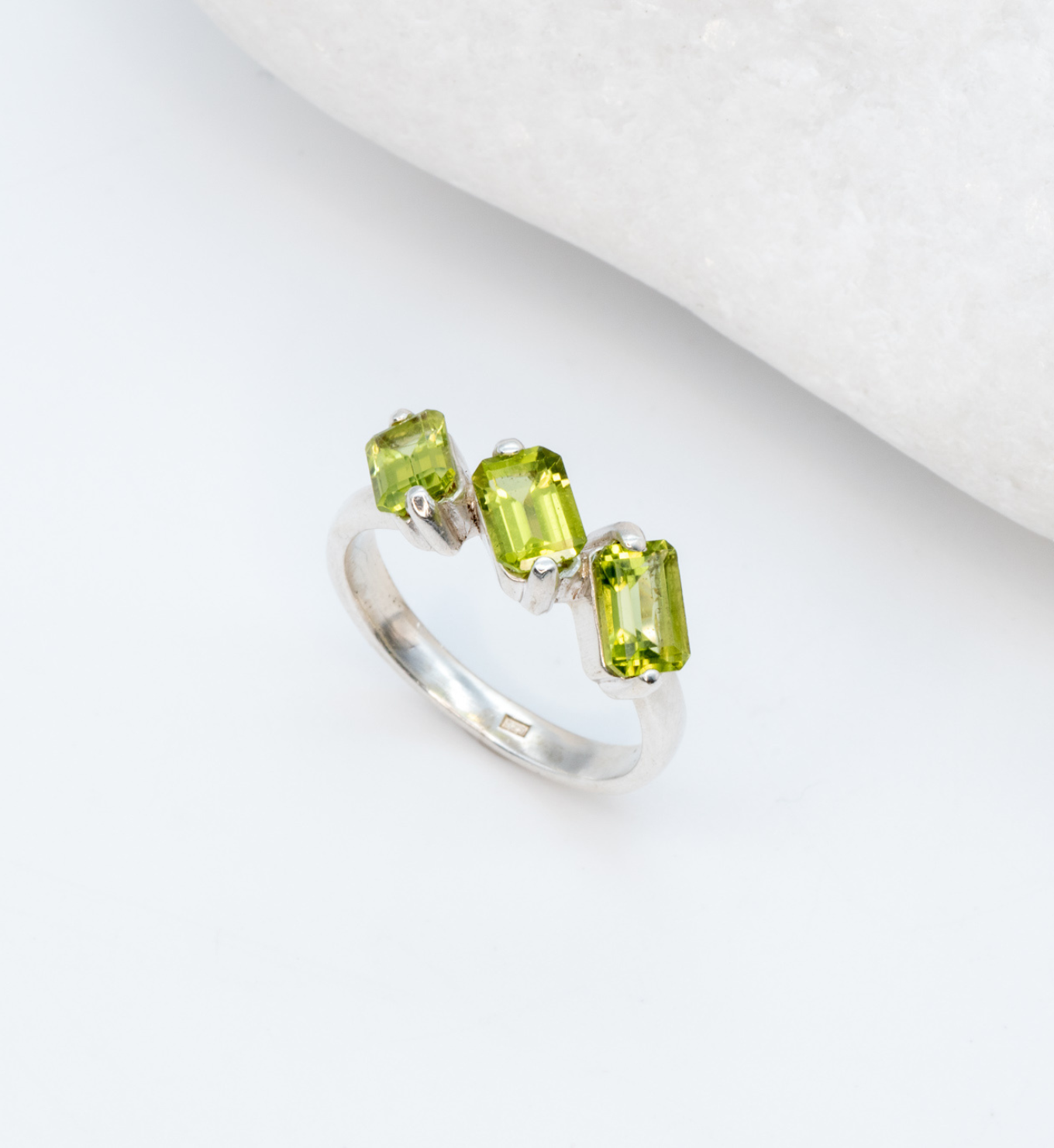 925 Sterling Silver ring with peridot august birthstone in baguette cut and prong setting. Three stone ring ideal for special occasions and personalized gift. Promotes emotional balance, joy, and clears negative energy. For abundance, healing, protection