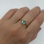 Closer shot of Gold Aquamarine Ring worn on middle finger