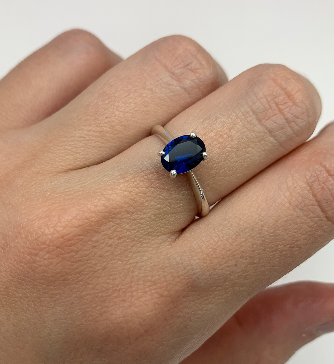 Closer shot of Oval Sapphire Ring worn on middle finger