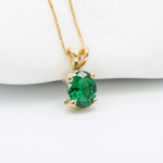 Green Emerald May birthstone Necklace crafted in 18k yellow gold over solid 925 sterling silver. Oval emerald gemstone encourages growth, harmony, and deep emotional healing. Solitaire pendant perfect anniversary present, ideal for casual and formal wear.