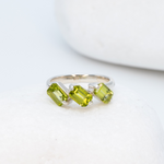 925 Sterling Silver ring with peridot august birthstone in baguette cut and prong setting. Dainty ring ideal for special occasions and gift ideas. Promotes emotional balance, joy, and clears negative energy. For abundance, healing, protection