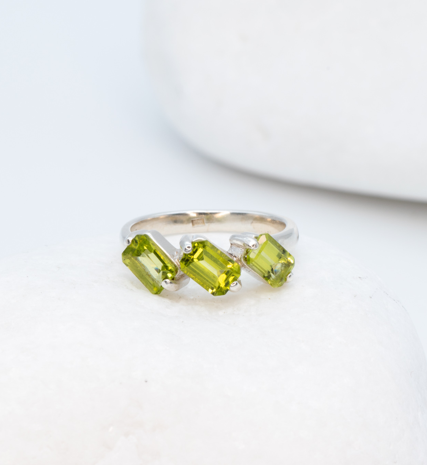 925 Sterling Silver ring with peridot august birthstone in baguette cut and prong setting. Dainty ring ideal for special occasions and gift ideas. Promotes emotional balance, joy, and clears negative energy. For abundance, healing, protection