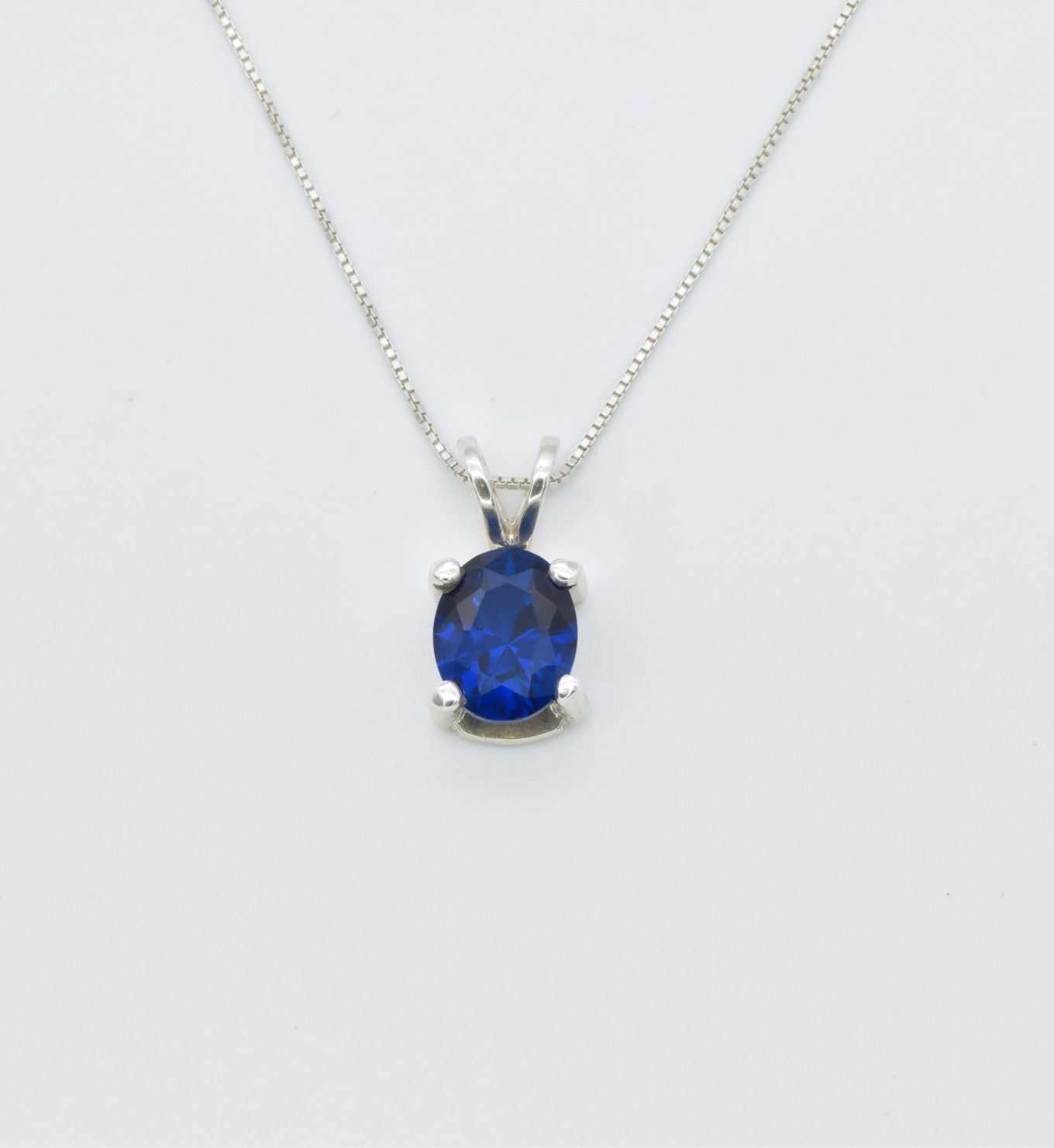 925 Sterling Silver necklace with Sapphire September birthstone in oval cut and prong setting. Solitaire pendant ideal gift for her, and for everyday wear. Blue sapphire pendant encourages truth, mental clarity, and spiritual insight. For wisdom, loyalty, focus